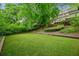 Expansive backyard with well-maintained lawn, mature trees, and partial view of the home's exterior at 185 Elizabeth St, Atlanta, GA 30307