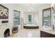 Bright bathroom with a chandelier, corner tub, vanity, and marble floors at 185 Elizabeth St, Atlanta, GA 30307
