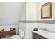 Neat bathroom with white tile, vanity with marble top, and a framed mirror at 185 Elizabeth St, Atlanta, GA 30307