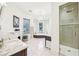 Bright bathroom featuring a corner tub, shower, vanity, and white marble floors at 185 Elizabeth St, Atlanta, GA 30307