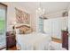 Bright bedroom featuring a chandelier, storage closet, and hardwood floors at 185 Elizabeth St, Atlanta, GA 30307