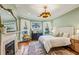 Bright bedroom featuring a decorative fireplace, ceiling fan, and sun-filled windows at 185 Elizabeth St, Atlanta, GA 30307