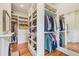 Spacious walk-in closet featuring wood floors, ample shelving, and a mirror at 185 Elizabeth St, Atlanta, GA 30307