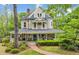 Beautiful two-story home featuring a wrap-around porch and well-manicured lawn at 185 Elizabeth St, Atlanta, GA 30307