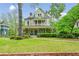 Charming home with a curved porch, manicured lawn, and beautiful landscaping, creating a welcoming atmosphere at 185 Elizabeth St, Atlanta, GA 30307