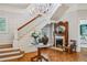 Foyer showcasing the staircase, chandelier, decorative fireplace, and patterned hardwood flooring at 185 Elizabeth St, Atlanta, GA 30307
