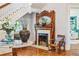 Elegant foyer featuring staircase, mirror, decorative fireplace, and hardwood floors at 185 Elizabeth St, Atlanta, GA 30307