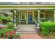 Inviting front porch featuring comfortable seating and decorative hanging plants at 185 Elizabeth St, Atlanta, GA 30307
