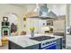 Gourmet kitchen boasts stainless steel appliances, large island with cooktop, and an open layout at 185 Elizabeth St, Atlanta, GA 30307