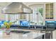 Close-up view of the kitchen island with gas cooktop, granite counters, and stainless steel appliances at 185 Elizabeth St, Atlanta, GA 30307