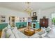 Cozy living room featuring a fireplace, hardwood floors, and elegant chandelier lighting at 185 Elizabeth St, Atlanta, GA 30307