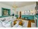 Bright living room featuring hardwood floors, built-in bar, fireplace, and comfortable seating at 185 Elizabeth St, Atlanta, GA 30307