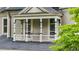 Charming porch features decorative columns, detailed railing, seating, and an elegant design at 185 Elizabeth St, Atlanta, GA 30307