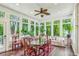 Bright sunroom with windows, ceiling fan, hardwood floors, and plants at 185 Elizabeth St, Atlanta, GA 30307