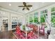 Bright sunroom with windows, ceiling fan, hardwood floors, and plants at 185 Elizabeth St, Atlanta, GA 30307