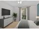 Inviting bedroom features a window, dresser, and a large screen TV at 3486 Essex Ave # 88, Atlanta, GA 30339