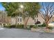 A brick building with well manicured landscaping is surrounded by mature trees on a sunny day at 3486 Essex Ave # 88, Atlanta, GA 30339