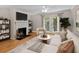 Cozy living room features fireplace, TV, modern furniture, and bright light at 3486 Essex Ave # 88, Atlanta, GA 30339