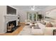 Bright living room features a fireplace, hardwood floors, and access to a balcony at 3486 Essex Ave # 88, Atlanta, GA 30339