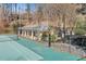 Aerial view of a tennis court with basketball hoops next to the pool and clubhouse at 3486 Essex Ave # 88, Atlanta, GA 30339