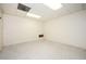This basement boasts neutral colors, a drop ceiling, and plush carpet flooring at 4157 Lake Mist Nw Dr, Kennesaw, GA 30144
