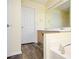 Bathroom featuring wooden cabinets, a large mirror, and wood flooring at 4157 Lake Mist Nw Dr, Kennesaw, GA 30144