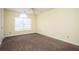 Bright bedroom featuring neutral paint, carpet, and a window for natural light at 4157 Lake Mist Nw Dr, Kennesaw, GA 30144