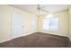 Cozy bedroom featuring neutral carpet, a ceiling fan, and natural light from a window at 4157 Lake Mist Nw Dr, Kennesaw, GA 30144