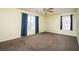 Bedroom featuring two windows with curtains, neutral paint, and comfortable carpet flooring at 4157 Lake Mist Nw Dr, Kennesaw, GA 30144
