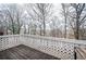 A wooden deck area with white lattice railing offers views of surrounding trees at 4157 Lake Mist Nw Dr, Kennesaw, GA 30144