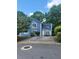 Inviting two-story home with blue siding, white trim, and a spacious driveway framed by lush trees at 4157 Lake Mist Nw Dr, Kennesaw, GA 30144