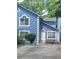 Charming two-story home with a striking blue facade, white trim, and well-manicured landscaping at 4157 Lake Mist Nw Dr, Kennesaw, GA 30144