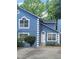 Charming two-story home with a striking blue facade, white trim, and well-manicured landscaping at 4157 Lake Mist Nw Dr, Kennesaw, GA 30144