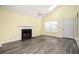Living room features a charming fireplace, skylight, updated flooring, and plenty of natural light at 4157 Lake Mist Nw Dr, Kennesaw, GA 30144