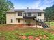 Two-story home with a deck and walkout basement in a wooded setting at 541 Mckenzie Ave, Stockbridge, GA 30281