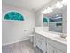 Modern bathroom with double vanity, decorative mirrors and windows, and sleek tile flooring at 541 Mckenzie Ave, Stockbridge, GA 30281