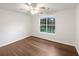Bedroom features include a ceiling fan, hardwood floor, and window overlooking trees at 541 Mckenzie Ave, Stockbridge, GA 30281