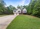 Traditional two-story home with attached garage, situated on a lush green lawn at 541 Mckenzie Ave, Stockbridge, GA 30281