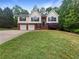Charming two-story home featuring a two-car garage and a well-manicured front lawn at 541 Mckenzie Ave, Stockbridge, GA 30281