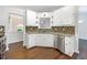 Stylish kitchen with white cabinets, granite countertops, stainless steel appliances, and modern backsplash at 541 Mckenzie Ave, Stockbridge, GA 30281