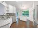 Bright kitchen featuring white cabinets, granite countertops, and stainless steel appliances at 541 Mckenzie Ave, Stockbridge, GA 30281