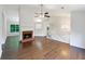 Bright living room with wood flooring, fireplace, and a view into the kitchen at 541 Mckenzie Ave, Stockbridge, GA 30281