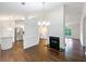 Open-concept living room with a fireplace, hardwood floors, and seamless flow to the kitchen at 541 Mckenzie Ave, Stockbridge, GA 30281