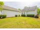 Manicured backyard featuring green lawn and trimmed hedges creating a private outdoor space at 6053 Park Close, Fairburn, GA 30213