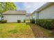 Well-maintained backyard featuring healthy lawn, trimmed shrubbery, and a clean home exterior at 6053 Park Close, Fairburn, GA 30213
