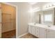 Bright bathroom featuring a double sink vanity and a spacious walk-in closet at 6053 Park Close, Fairburn, GA 30213