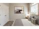 Stylishly staged bedroom with plush carpeting, neutral walls, and a bedside table with a lamp at 6053 Park Close, Fairburn, GA 30213