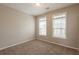 Neutral bedroom with plush carpeting, two windows and light beige paint at 6053 Park Close, Fairburn, GA 30213