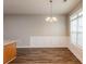 Bright dining room with hardwood floors and modern chandelier at 6053 Park Close, Fairburn, GA 30213