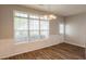 Dining area features lovely paneling, hardwood floors, and a contemporary chandelier at 6053 Park Close, Fairburn, GA 30213